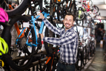Young man in bicycles shop