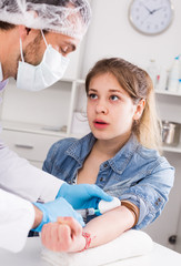 Doctor injecting teenage girl