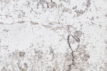 Cracked concrete texture background. Grey surface with cracks close up. Cracked grey old wall as background.