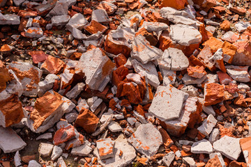 Destroyed brick wall. Red bricks are chaotic. Demolition of an old brick house. Brick destroyed background.
