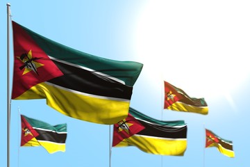 nice 5 flags of Mozambique are waving against blue sky photo with bokeh - any occasion flag 3d illustration..