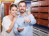 Couple looking for postbox for their apartment in specialty store
