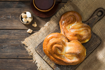 Bun sprinkled with sugar. Sweet pastries. Rustic style