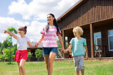 Obraz premium Daughter feeling excited walking with mommy and brother