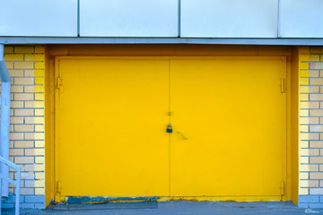 bright yellow metal door from the garage locked
