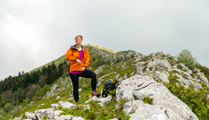 Naklejka na ściany i meble Woman Hiking alone in the mountains 