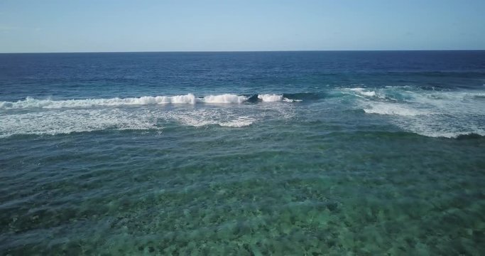 Aerial, Waves rolling over pristine shallow sea at Foa Island, Tonga