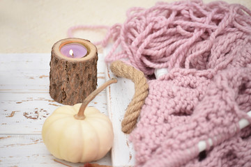 Obraz na płótnie Canvas Autumn still life with knitting in the autumn garden. Rough knitting and knitting needles.