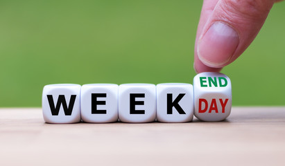 Hand turns a dice and changes the word "weekday" to "weekend".