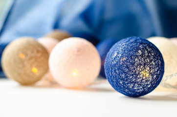 Christmas light garland. Wicker balls. Background.