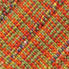 Fototapeta na wymiar Multicolored handwoven woolen fabric with pattern