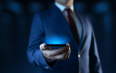 Businessman holding smartphone. Man using phone in office