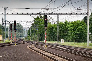 Red semaphores and railway tracks. Traffic lights shows red signal on railway.