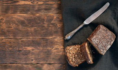 Fresh baked cereal bread on a wooden cutting board background with a copy space.