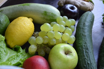 Healthy food clean eating selection: fruit, vegetable, seeds, superfood, cereal, leaf vegetable on gray concrete background
