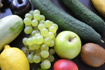 Healthy food clean eating selection: fruit, vegetable, seeds, superfood, cereal, leaf vegetable on gray concrete background