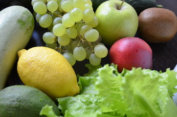 Healthy food clean eating selection: fruit, vegetable, seeds, superfood, cereal, leaf vegetable on gray concrete background