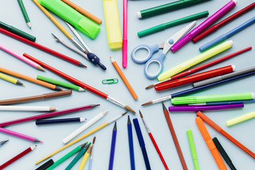 Scattered stationery on blue table