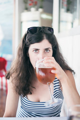 beauty woman drinking a cup of beer in restaurant