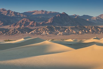 Fototapeta na wymiar Sand Dune Formations over beautiful sunrise in Death Valley National Park, California, USA Mesquite Flat Sand Dunes formations with amazing structure sand. America desert