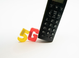 5G telecommunications text letters pushing an old school phone out of the way