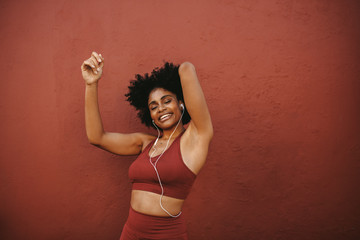 Relaxed woman listening to music after workout