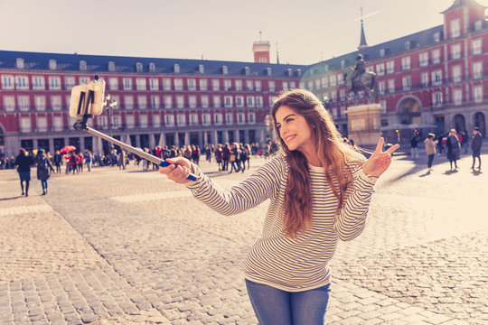 Attractive happy young woman taking a self picture. In tourism leisure outdoors concept
