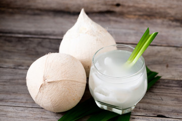 Fresh coconut juice in a glass with coconut white meat isolated on white