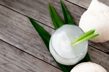 Fresh coconut juice in a glass with coconut white meat isolated on white