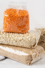 Various cereal grains, groats in transparent plastic bags.