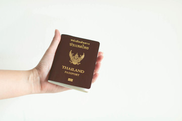Hand showing passport of Thailand on white background.