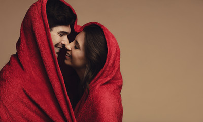 Couple in love wrapped in a blanket © Jacob Lund