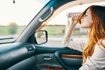 Fototapeta na wymiar young woman driving a car