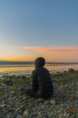 silhouette of man on beach at sunset