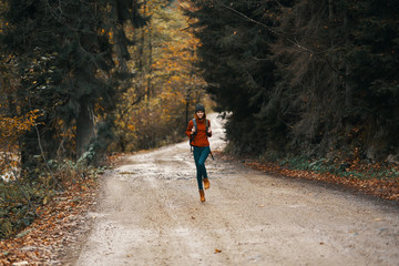 young woman running in the forest