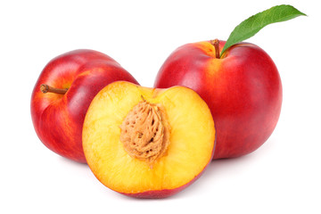 Nectarine with green leaf and slices isolated on white background