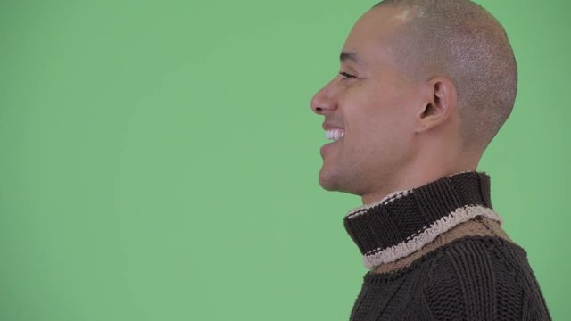 Closeup profile view of happy bald multi ethnic man talking ready for winter
