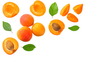 apricot fruits with slices and green leaf isolated on white background. top view