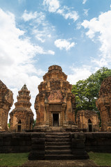 Fototapeta na wymiar Khmer Castle in Thailand Made of large brown-orange stones arranged together and carved into beautiful architecture.(Prasat Sikhoraphum, Surin, Thailand)