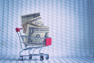 Shopping cart with dollar banknote USD retro color effected © littlestocker