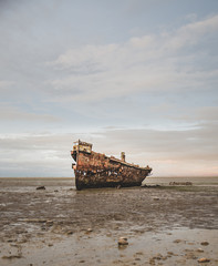 Old boat rusting on the beach