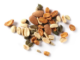 Healthy food mix of salted and spicy peanuts, sunflower and pumpkin seeds, almonds isolated on white background, top view