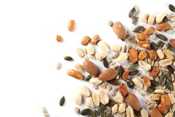 Healthy food mix of salted and spicy peanuts, sunflower and pumpkin seeds, almonds isolated on...