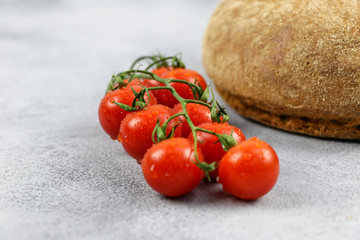 country bread and tomato on grey background