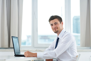 Naklejka na ściany i meble portrait of a businessman working on his laptop