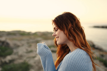 woman in a sweater in the evening in nature