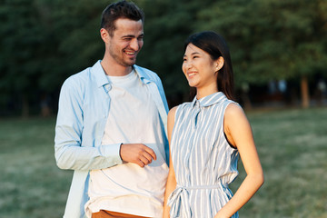 happy young couple walking in the park