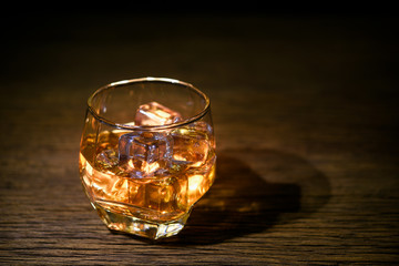 wisky on the rocks on wood