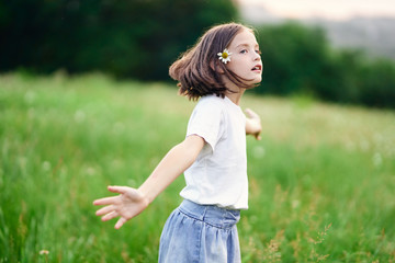 girl with a flower in her hair in the field