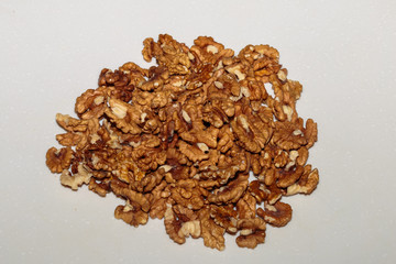 Heap kernels of walnut on a kitchen table. Concept of healthy vegan food.